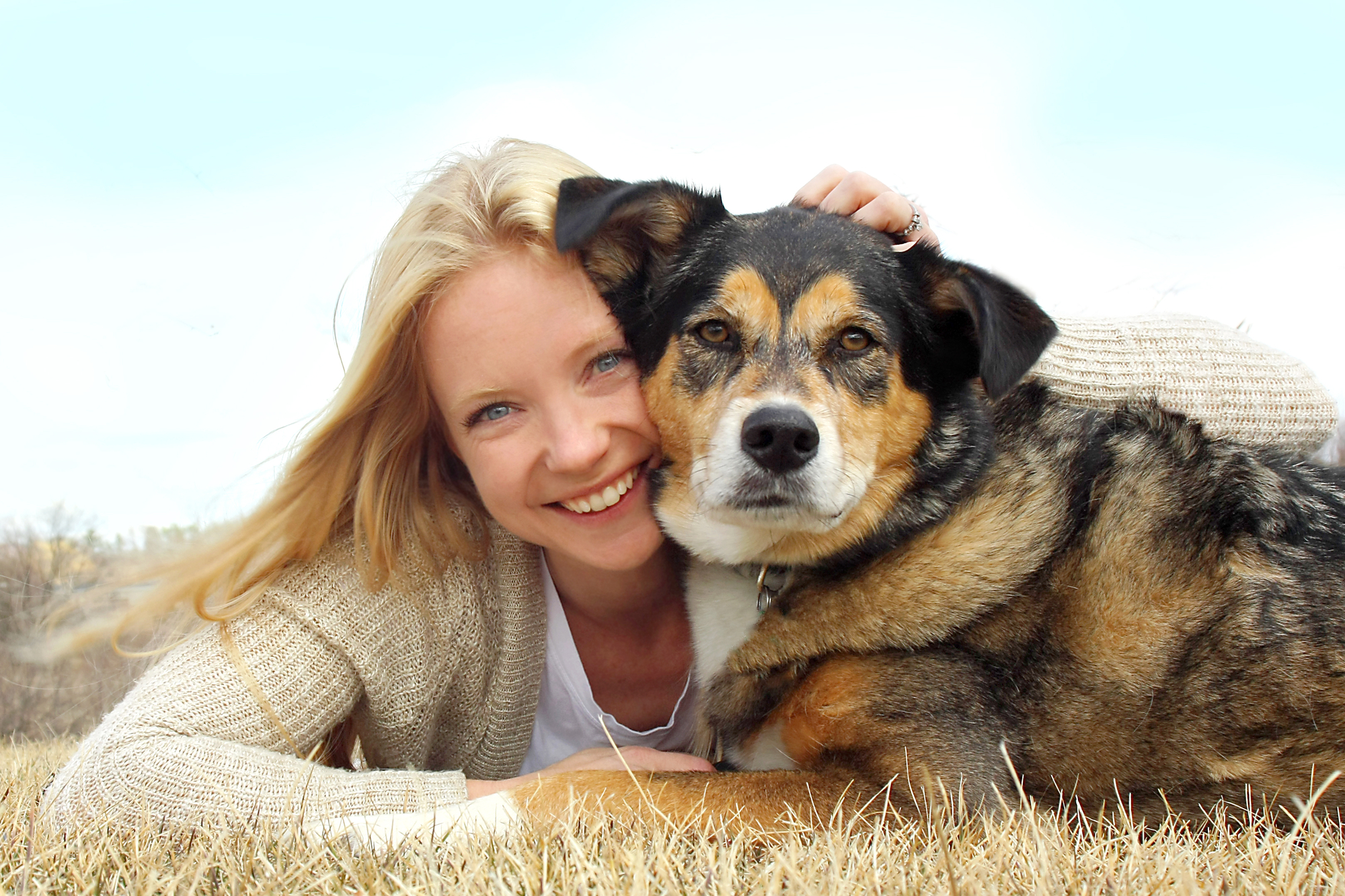 Smiling Woman Hugging German Shepherd Dog