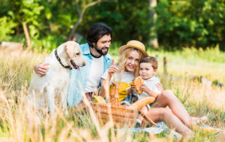 young family with yellow lab picnic